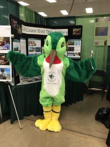 life size hummingbird in costume stands in front of info booth